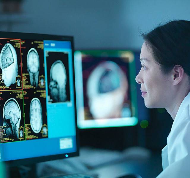 A doctor is looking at a brain scan on the computer.