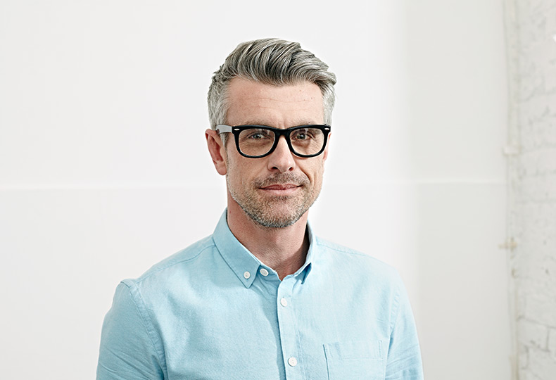 A person in a light blue shirt and glasses