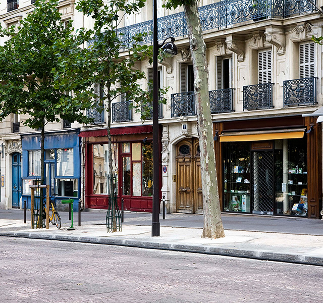 A street with shops in the buildings.