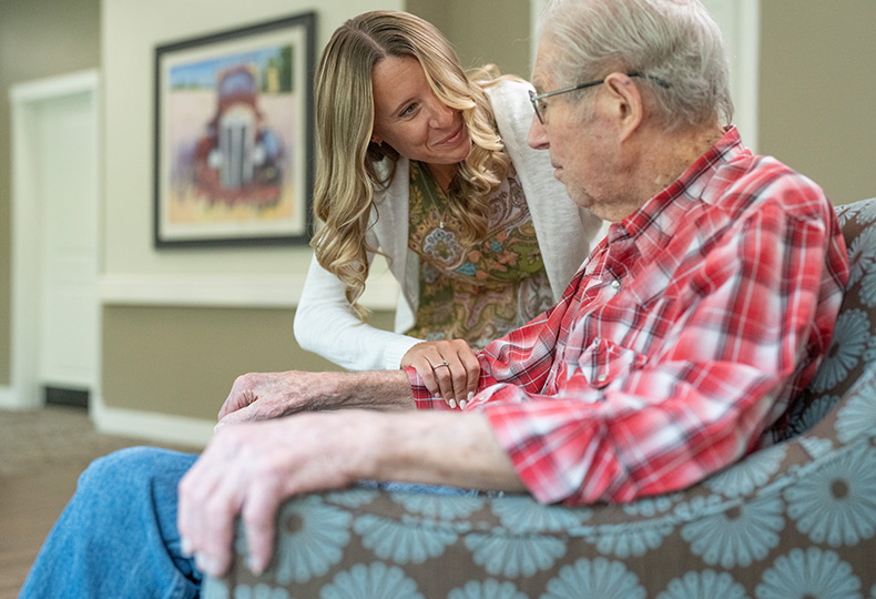 A resident is chatting with their caregiver.