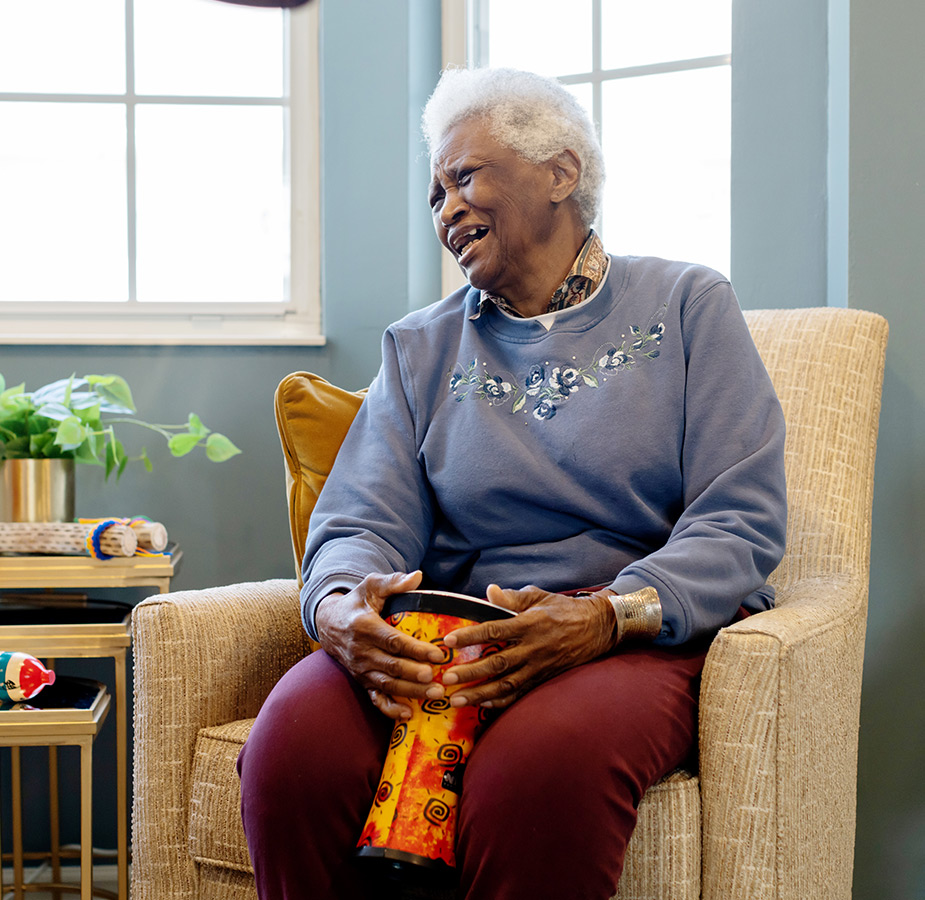 A resident playing a bongo drum.