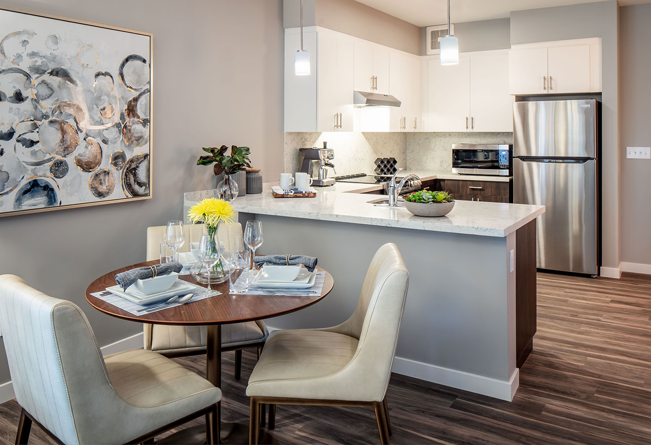 Furnished apartment with a kitchen, living room, and bedroom.