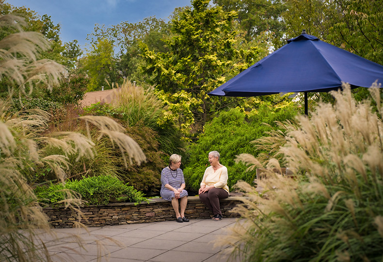 Two people sitting outside.