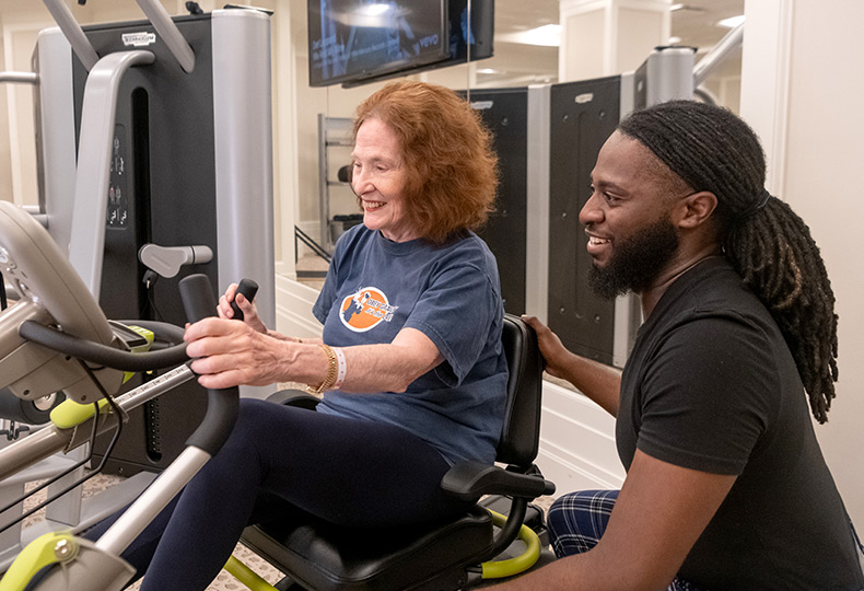 A person working out with a trainer.
