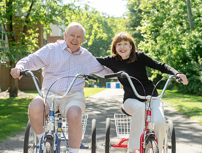 Two people riding bikes.