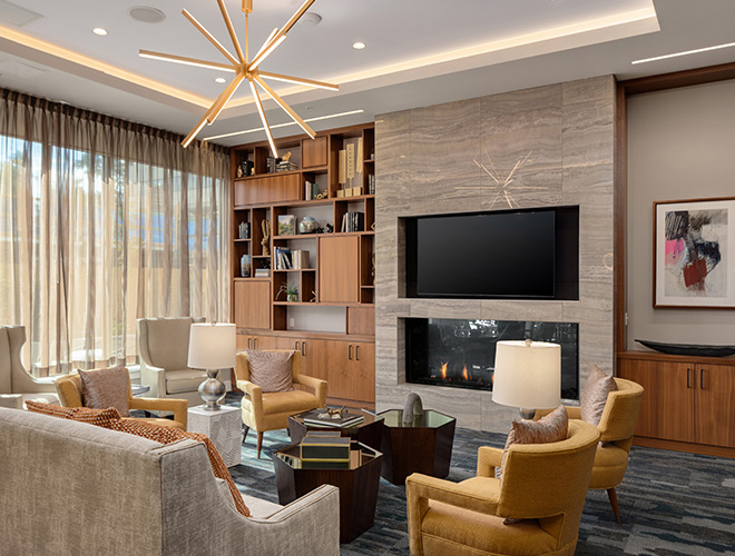 A common living room area with a tv and fireplace.