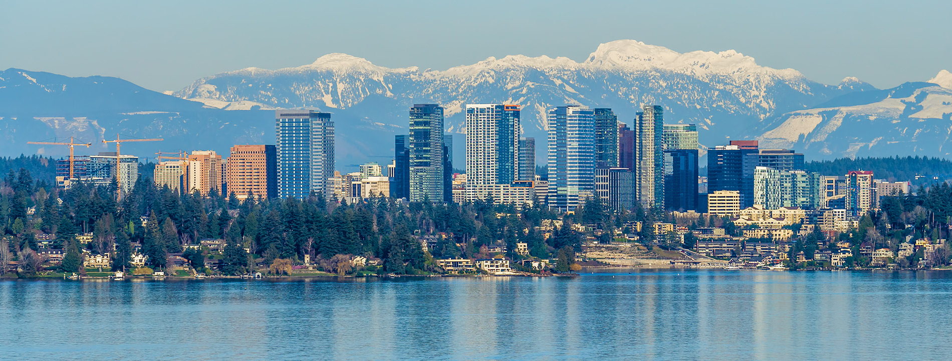 The skyline of Bellevue with mountains in the back.