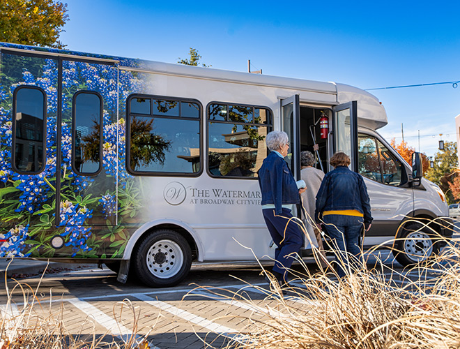 Residents getting on a Watermark bus.