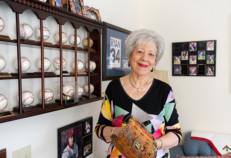 A resident in their apartment with baseball memorabilia.