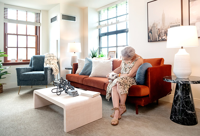 A resident is sitting with their dog.