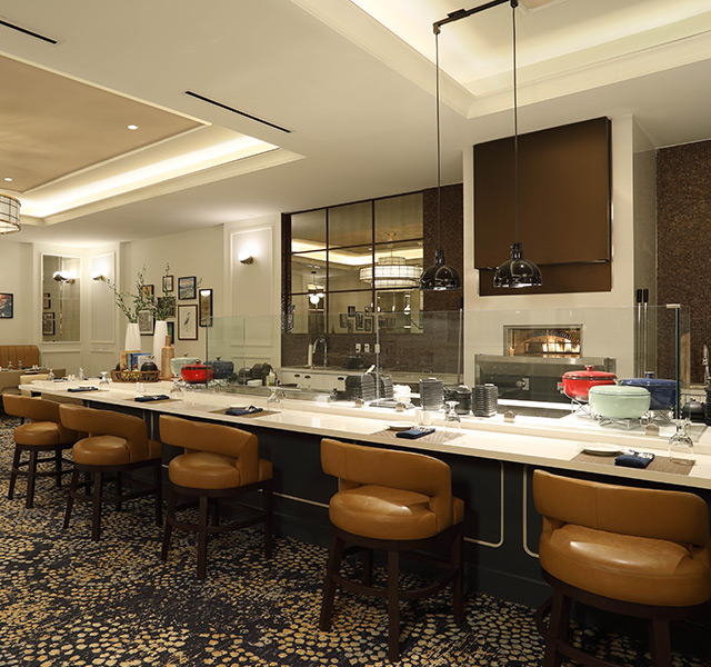 Taboon dining area with counter top seating and an exposed kitchen.