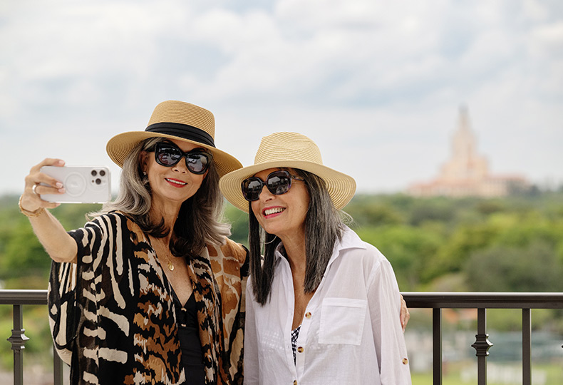 Two people taking a photo on the rooftop.