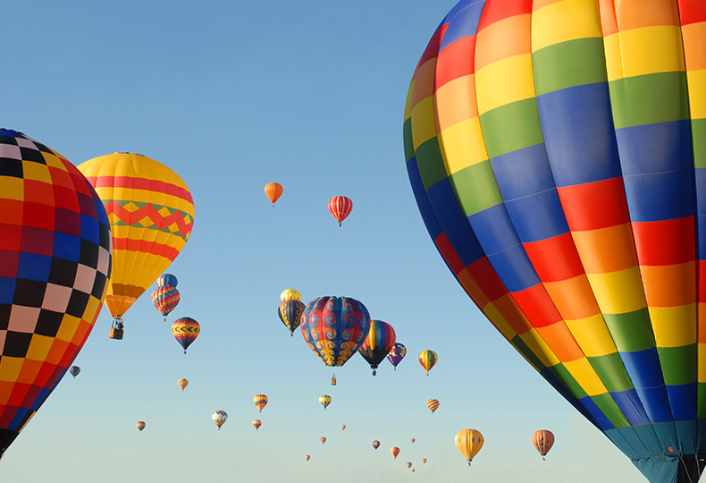 Hot air balloons are in the sky.