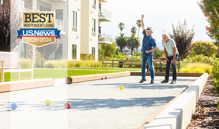 Two people playing bocce ball.