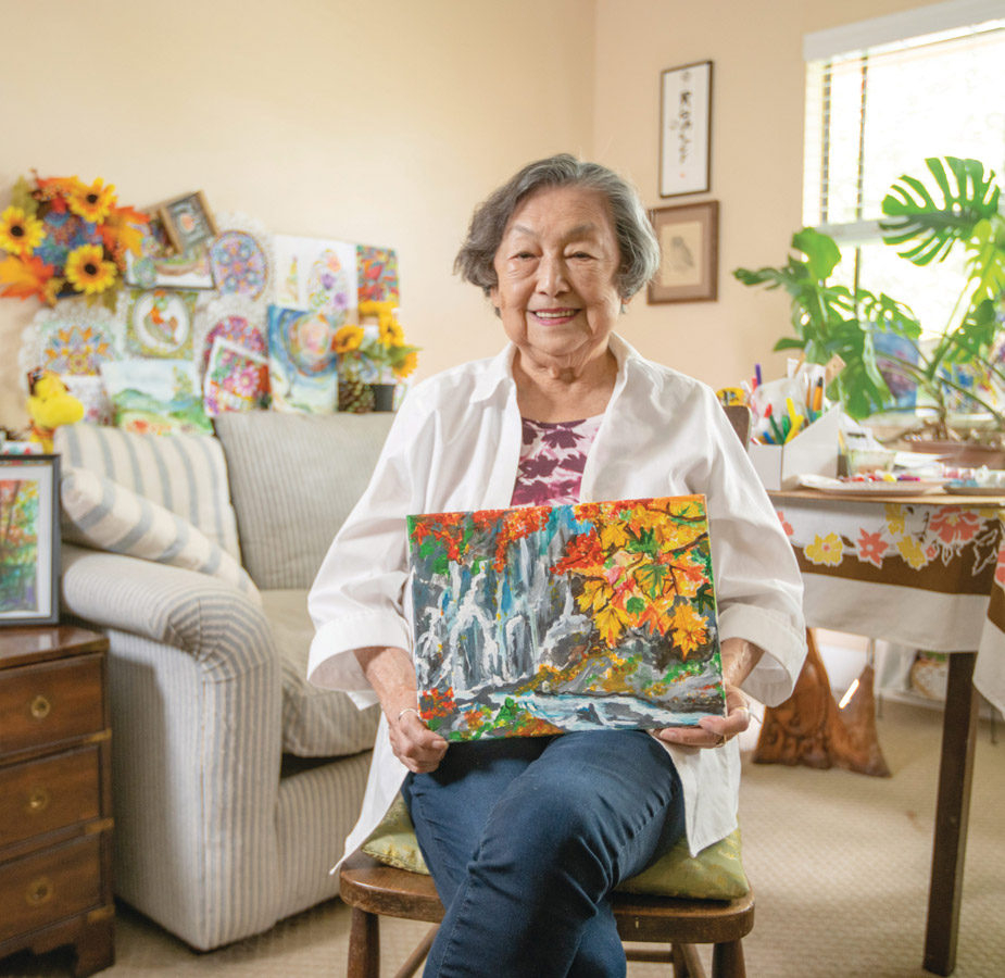 A resident is holding a painting.
