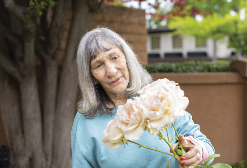 A resident is holding flowers.