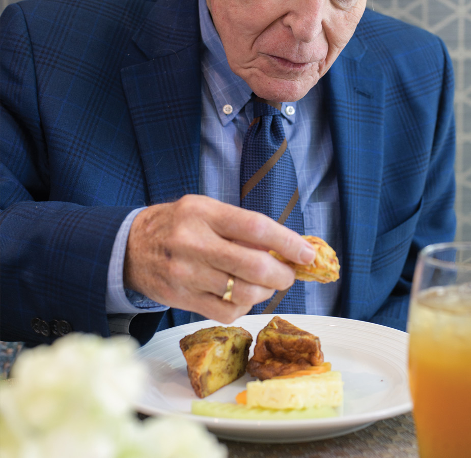 A resident eating gourmet bites.
