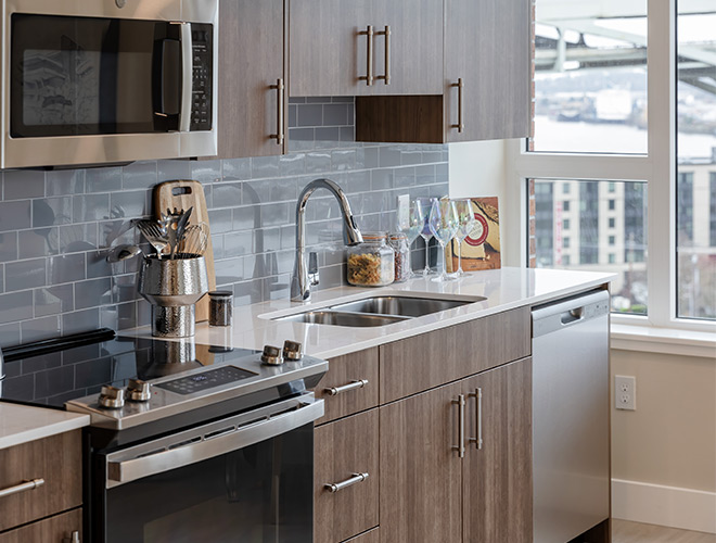 A kitchen with a view out the window.