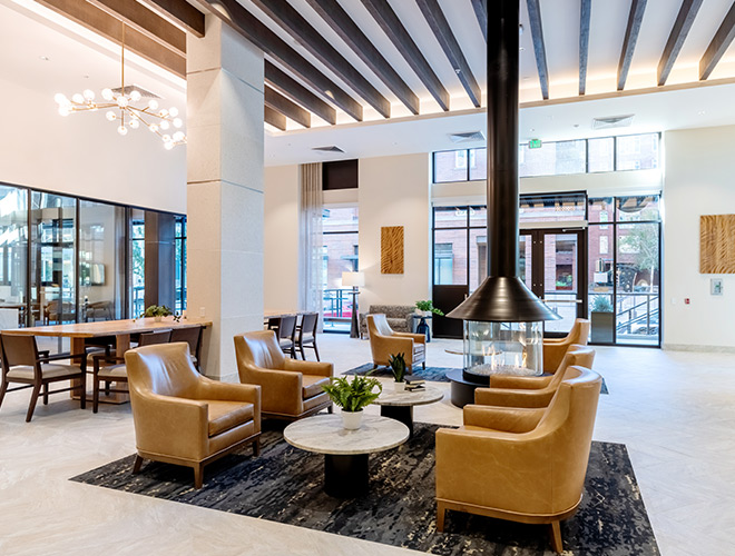 A lobby with seating and a fireplace.