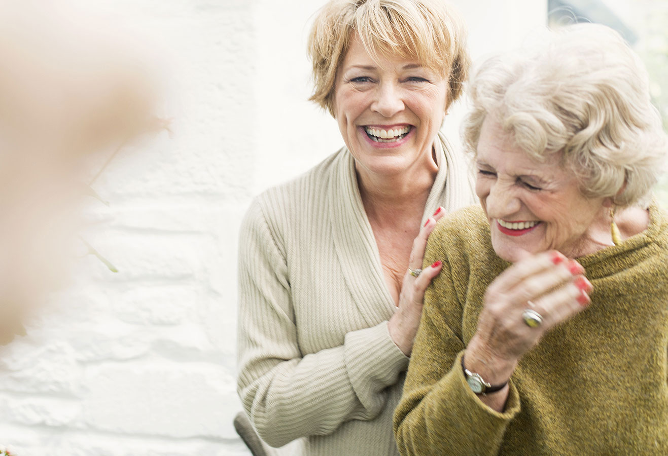 Residents laughing and hugging.