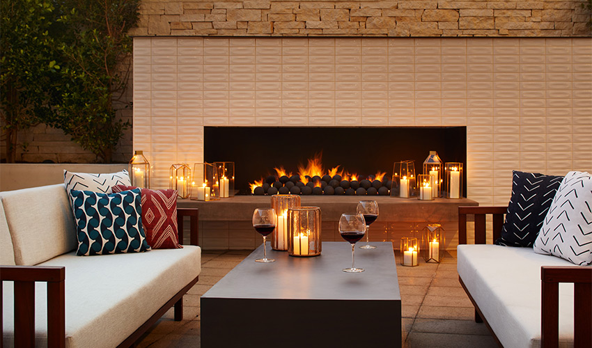 A cozy outdoor fireplace with seating.