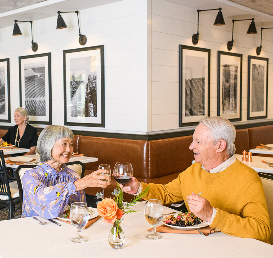 Two residents are eating in the dining area.