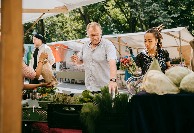 A resident is shopping at a farmers market.