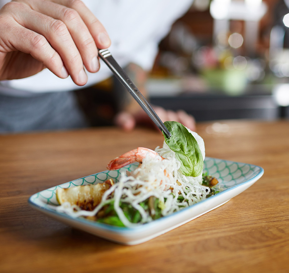 A chef plating food.