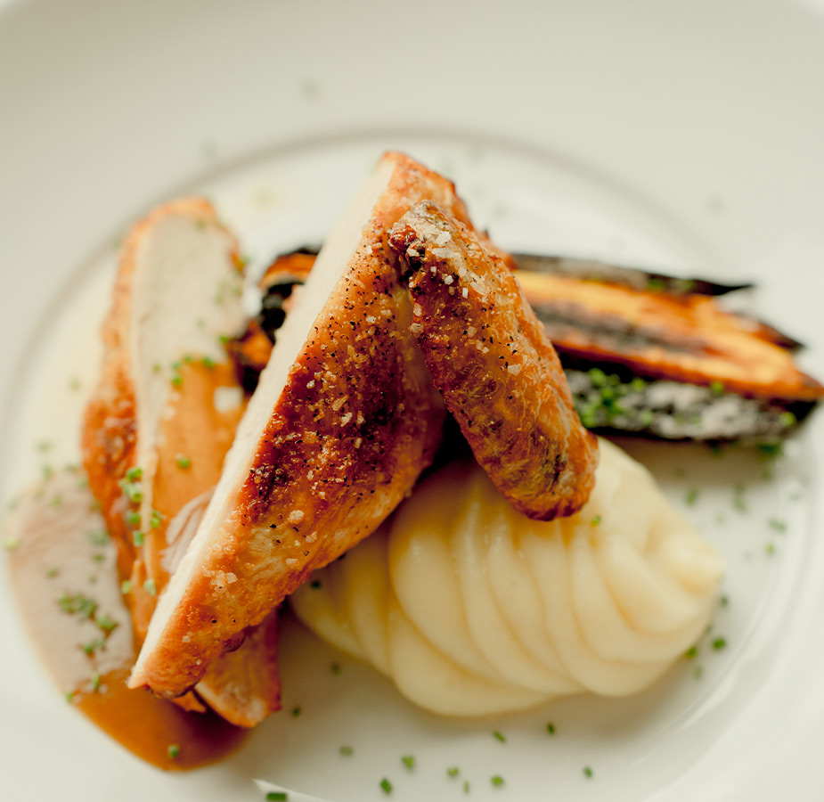 Chicken and mashed potatoes on a plate.
