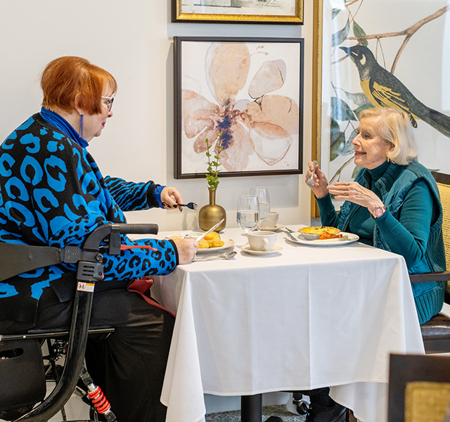 Two residents are having a meal together.