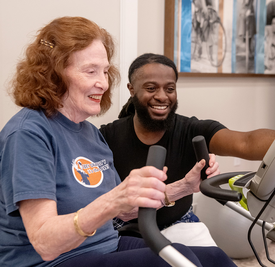 Trainer orienting resident on fitness practice.