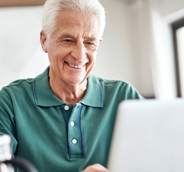 Smiling resident working on the computer.