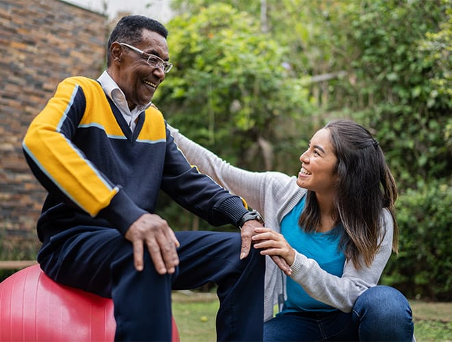 A resident working with an on-site physiotherapist to increase mobility