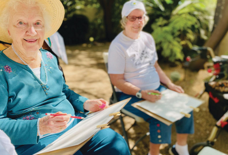 Residents enjoying an outdoor painting class