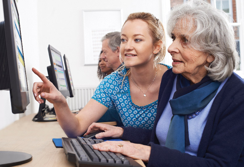 Associate teaching residents how to work a computer.