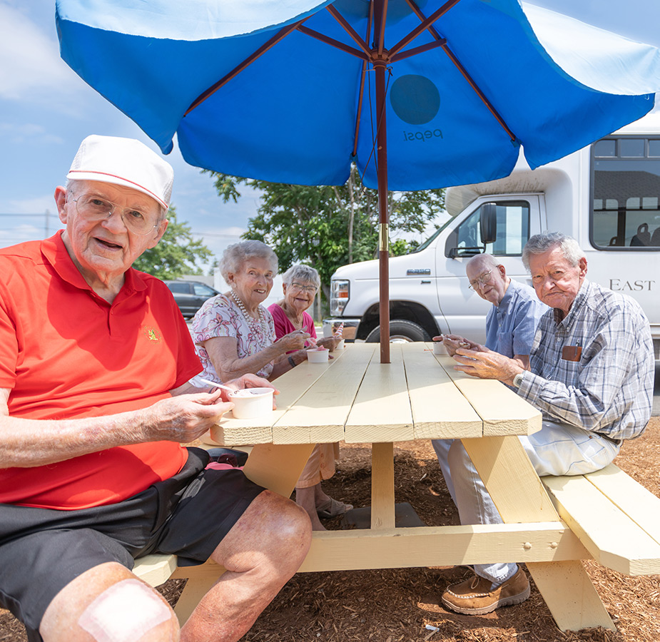 Residents are having ice cream together outside.