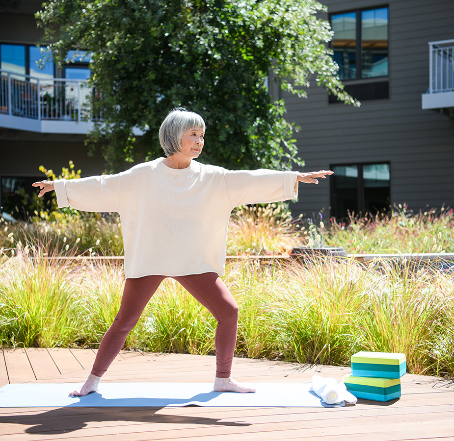 A resident is practicing yoga outside.