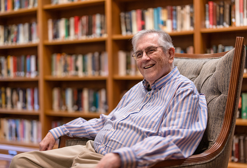 A resident is sitting in the library.