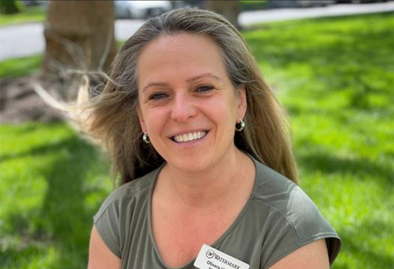 A person is outside smiling.