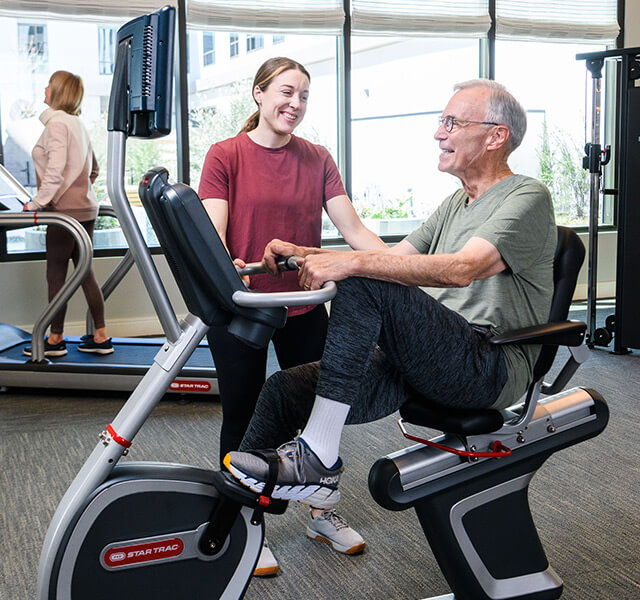 A resident is using a fitness machine.
