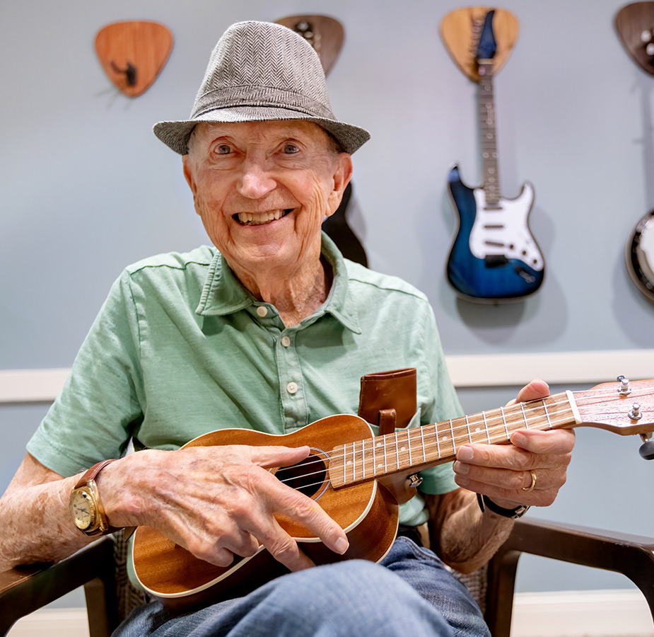 A resident playing the Ukulele.