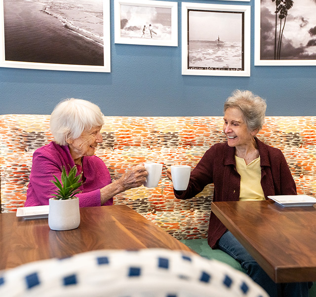 two people holding mugs
