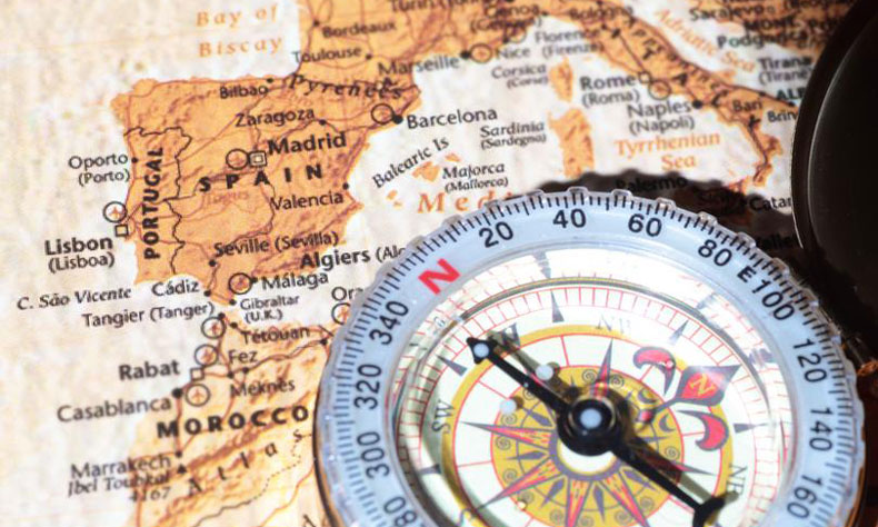 A compass is over a map.
