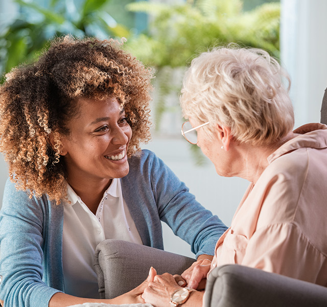 A resident is chatting with a caregiver.