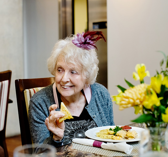 A resident eating gourmet bites.