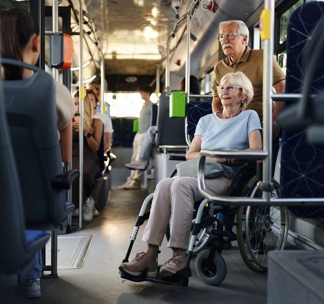 A women is in a wheelchair on a bus.