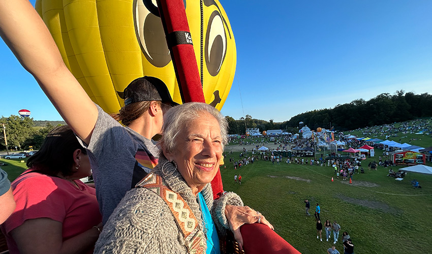 Three people in hot air balloon.