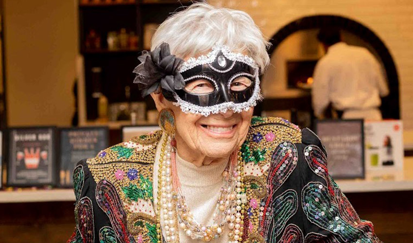 A person with a mardi gras mask on.