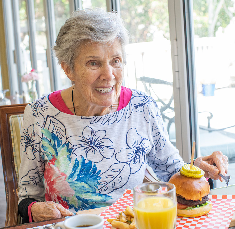 A resident is having a meal in the dining area.