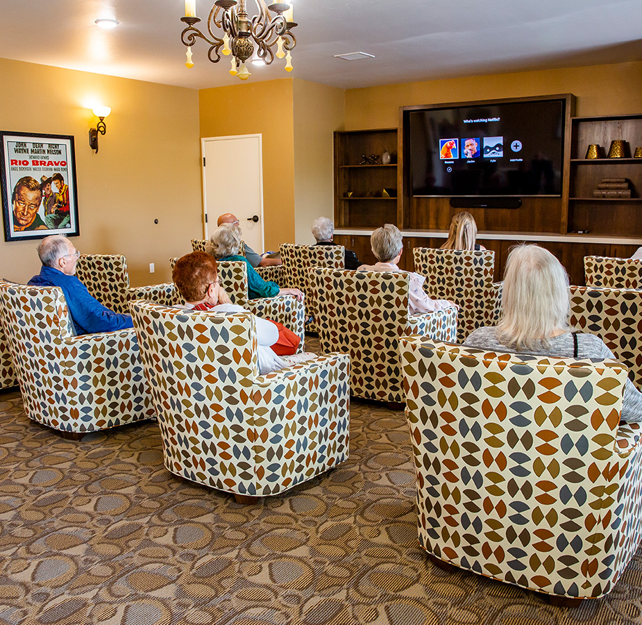 Residents are sitting in the theater room at Summit Senior Living.